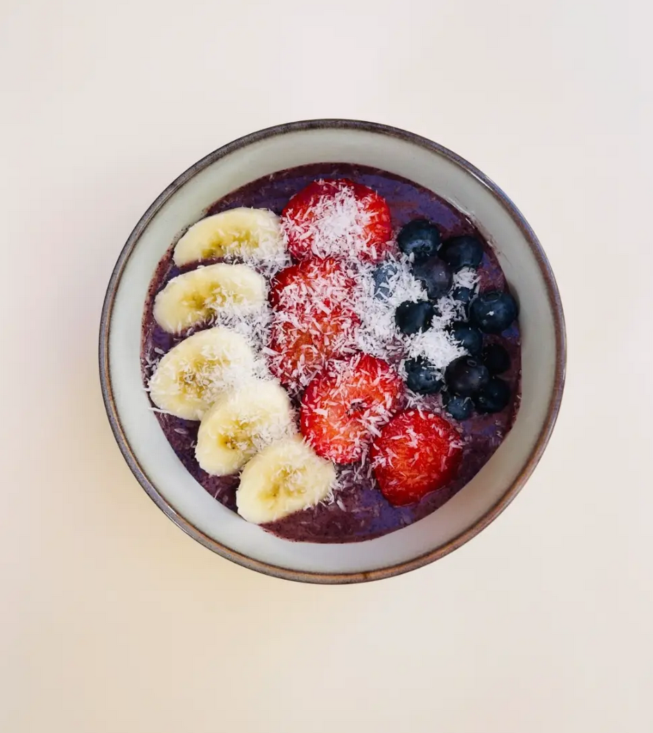 Fresh açaí bowl with banana, strawberries, blueberries and coconut